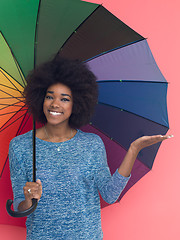 Image showing afro american woman holding a colorful umbrella