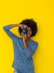 Image showing young african american girl taking photo on a retro camera