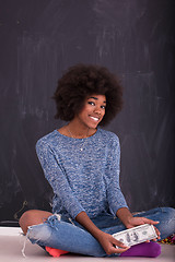 Image showing black woman holding money on gray background