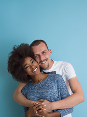 Image showing multiethnic couple laughing and hugging