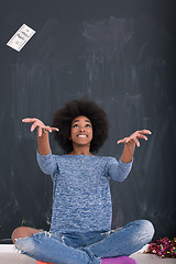 Image showing black woman throwing money