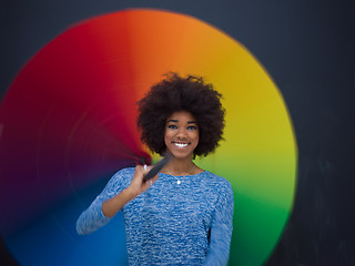 Image showing african american woman holding a colorful umbrella