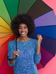 Image showing afro american woman holding a colorful umbrella