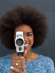 Image showing african american woman using a retro video camera