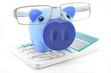 Image showing Piggybank with eyeglasses and calculator 