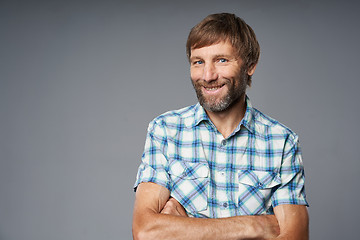 Image showing Smiling mature man in checkered shirt