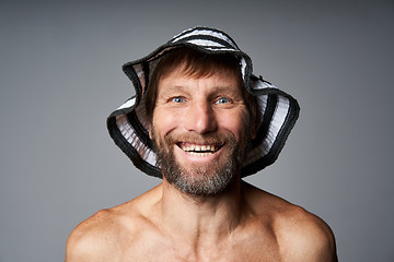 Image showing Funny portrait of mature man topless wearing summer hat
