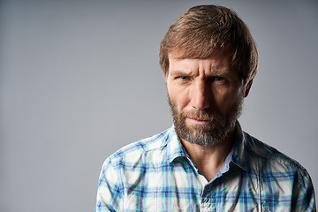 Image showing Studio portrait of smiling mature man in checkered shirt