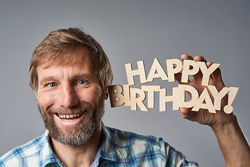 Image showing Studio portrait of smiling mature man in checkered shirt