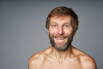 Image showing mature man shirtless standing smiling at camera