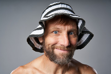 Image showing Funny portrait of mature man topless wearing summer hat