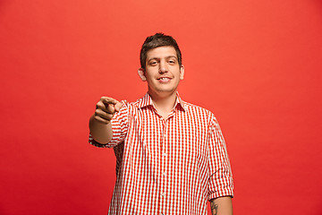 Image showing The overbearing businessman point you and want you, half length closeup portrait on red background.