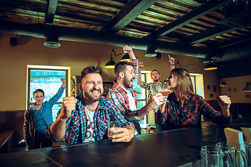 Image showing Sport, people, leisure, friendship and entertainment concept - happy football fans or male friends drinking beer and celebrating victory at bar or pub