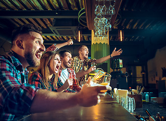 Image showing Sport, people, leisure, friendship and entertainment concept - happy football fans or male friends drinking beer and celebrating victory at bar or pub