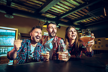 Image showing Sport, people, leisure, friendship and entertainment concept - happy football fans or male friends drinking beer and celebrating victory at bar or pub