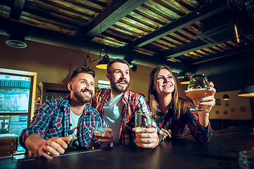 Image showing Sport, people, leisure, friendship and entertainment concept - happy football fans or male friends drinking beer and celebrating victory at bar or pub