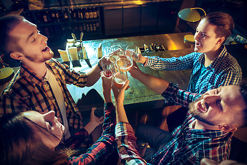 Image showing Sport, people, leisure, friendship and entertainment concept - happy football fans or male friends drinking beer and celebrating victory at bar or pub