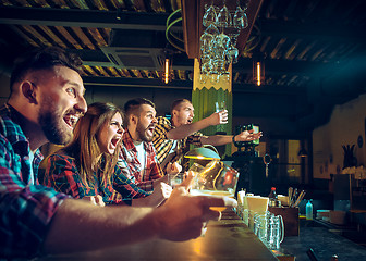 Image showing Sport, people, leisure, friendship and entertainment concept - happy football fans or male friends drinking beer and celebrating victory at bar or pub