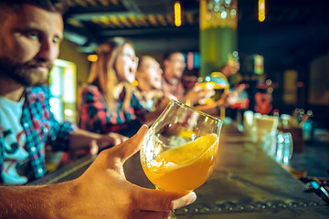 Image showing Sport, people, leisure, friendship and entertainment concept - happy football fans or male friends drinking beer and celebrating victory at bar or pub