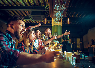 Image showing Sport, people, leisure, friendship and entertainment concept - happy football fans or male friends drinking beer and celebrating victory at bar or pub