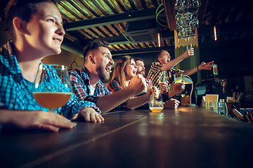 Image showing Sport, people, leisure, friendship and entertainment concept - happy football fans or male friends drinking beer and celebrating victory at bar or pub