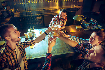 Image showing Sport, people, leisure, friendship and entertainment concept - happy football fans or male friends drinking beer and celebrating victory at bar or pub