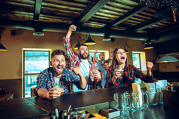 Image showing Sport, people, leisure, friendship and entertainment concept - happy football fans or male friends drinking beer and celebrating victory at bar or pub