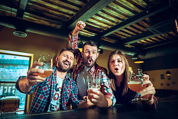 Image showing Sport, people, leisure, friendship and entertainment concept - happy football fans or male friends drinking beer and celebrating victory at bar or pub