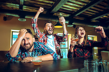 Image showing Sport, people, leisure, friendship and entertainment concept - happy football fans or male friends drinking beer and celebrating victory at bar or pub