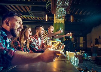 Image showing Sport, people, leisure, friendship and entertainment concept - happy football fans or male friends drinking beer and celebrating victory at bar or pub