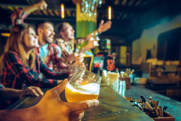 Image showing Sport, people, leisure, friendship and entertainment concept - happy football fans or male friends drinking beer and celebrating victory at bar or pub