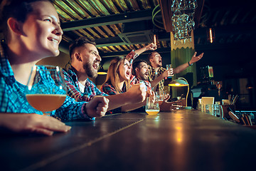 Image showing Sport, people, leisure, friendship and entertainment concept - happy football fans or male friends drinking beer and celebrating victory at bar or pub