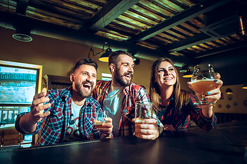 Image showing Sport, people, leisure, friendship and entertainment concept - happy football fans or male friends drinking beer and celebrating victory at bar or pub