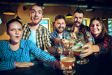 Image showing Sport, people, leisure, friendship and entertainment concept - happy football fans or male friends drinking beer and celebrating victory at bar or pub