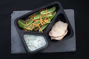 Image showing Lunch. Low-cost, balanced diet. Cooked meat on a sweet pea salad served with white yoghurt sauce.