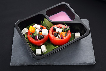 Image showing Prepared dish, stuffed tomatoes with pink yoghurt sauce