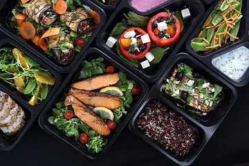 Image showing Lunch boxes, delicious and healthy dinner dishes. Food with delivery. Menu suggestions in catering with delivery.