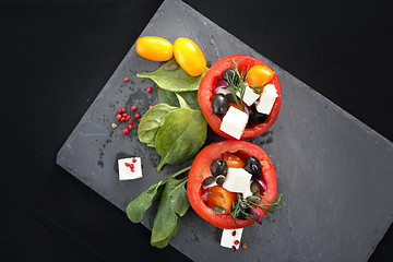 Image showing Prepared dish, stuffed tomatoes with pink yoghurt sauce