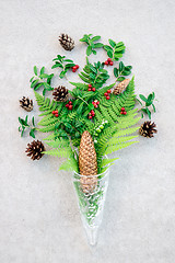 Image showing Glass cone with wild forest plants and berries