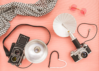 Image showing Vintage photo cameras on pink background