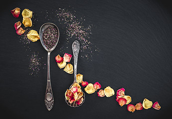 Image showing Silver spoons with floral tea and rose petals