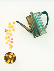 Image showing Vintage teapot and cup of tea with rose petals