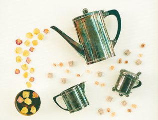 Image showing Vintage tea set and cup of tea with rose petals