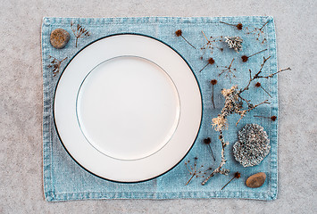 Image showing Table setting decorated with Scandinavian wild plants