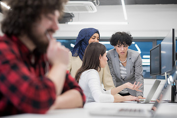 Image showing young multiethnics team of software developers working together