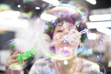 Image showing software developer having fun while making soap bubble