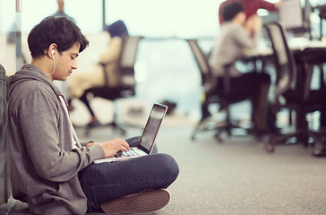 Image showing software developer working on the floor