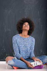 Image showing black woman holding money on gray background