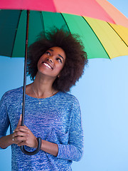 Image showing beautiful black woman holding a colorful umbrella