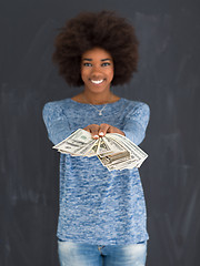 Image showing black woman holding money on gray background